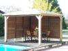 Kiosque en Bois avec vantelles mobiles devant une piscine